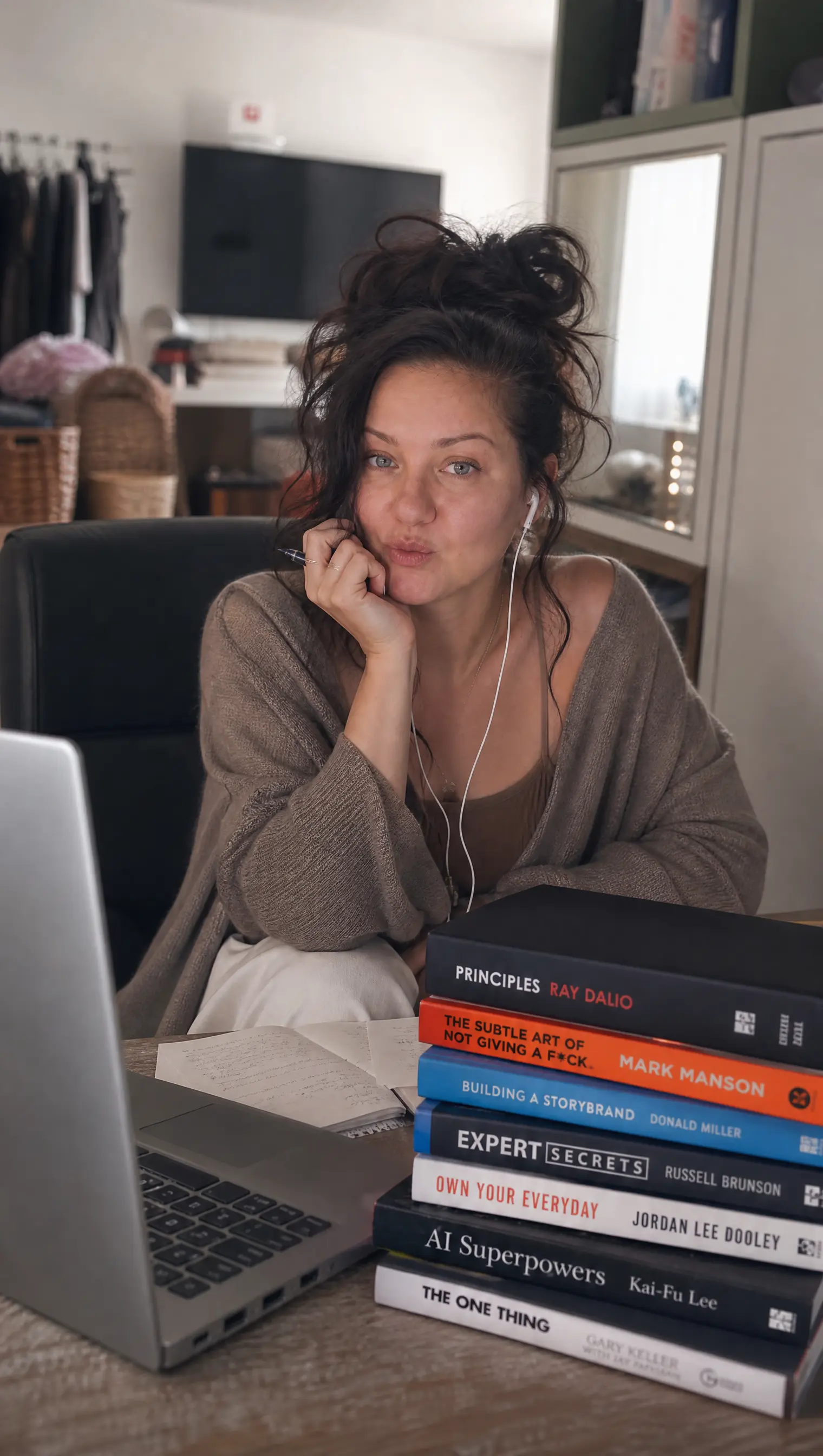 At the desk with a stack of business books